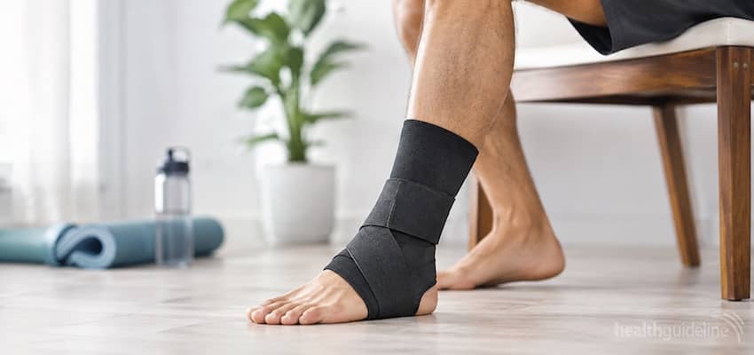 Adult wearing an ankle support brace in a bright wellness room for Achilles tendonitis support, stability, and recovery.