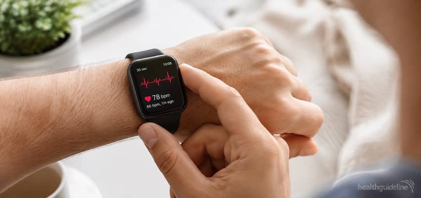 FDA-approved ECG smartwatch displaying a heart rhythm reading and heart rate while being used for personal health monitoring.