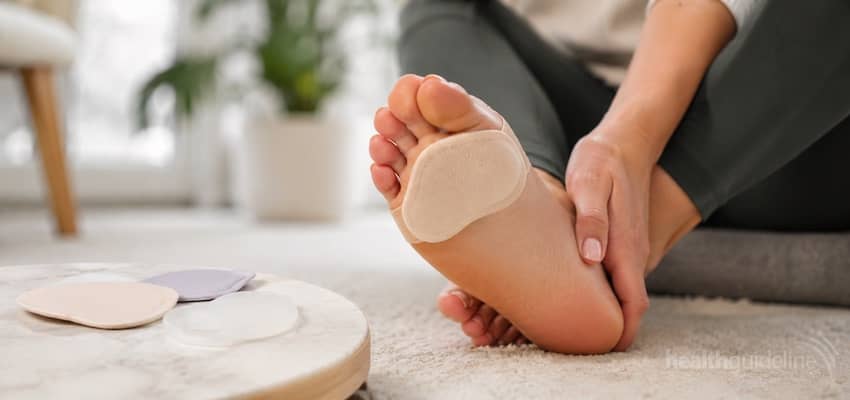Person wearing a soft metatarsal pad under the ball of the foot to help cushion pressure and relieve forefoot pain.